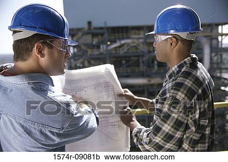 Two foremen working on blueprints View Large Photo Image Stock Image - Two foremen working on blueprints. Fotosearch