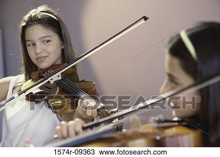 Two girls playing the violin View Large Photo Image Stock Image - Two girls playing the violin. Fotosearch