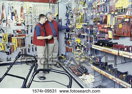 Two male clerks in a hardware store View Large Photo Image Stock Image - Two male clerks in a hardware store. Fotosearch