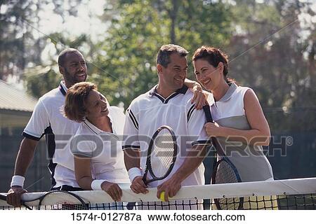 Two mid adult couples playing tennis View Large Photo Image Stock Image - Two mid adult couples playing tennis. Fotosearch