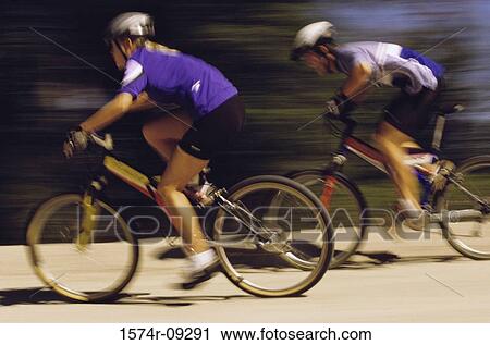 Stock Image - Two people cycling. Fotosearch