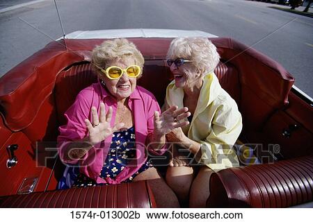 Two senior women traveling together in a convertible car View Large Photo Image Stock Image - Two senior women traveling together in a convertible car. Fotosearch