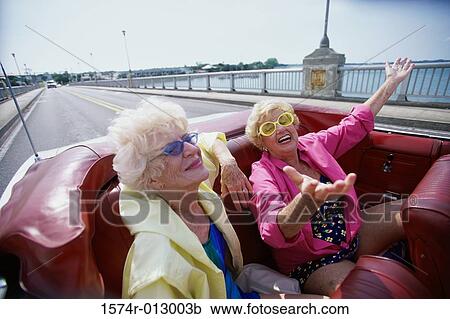 Two senior women traveling together in a convertible car View Large Photo Image Stock Image - Two senior women traveling together in a convertible car. Fotosearch