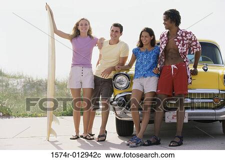 Two teenage couples leaning against a car View Large Photo Image Stock Image - Two teenage couples leaning against a car. Fotosearch