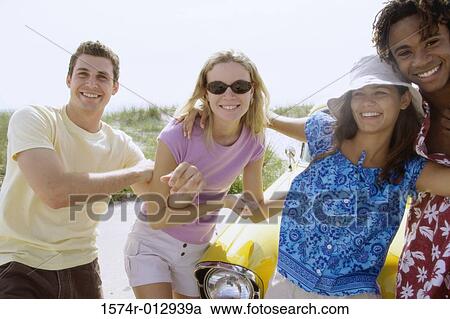 Stock Image - Two teenage couples standing together. Fotosearch