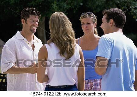 Stock Image - Two young couples talking to each other. Fotosearch