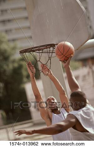 Two young men playing basketball View Large Photo Image Stock Image - Two young men playing basketball. Fotosearch