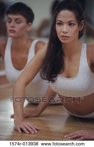 Stock Photo - Two young women exercising. Fotosearch