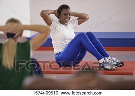 Stock Image - Woman exercising on the floor. Fotosearch