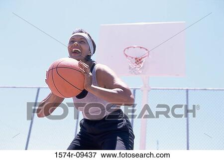 Woman holding a basketball View Large Photo Image Stock Photo - Woman holding a basketball. Fotosearch