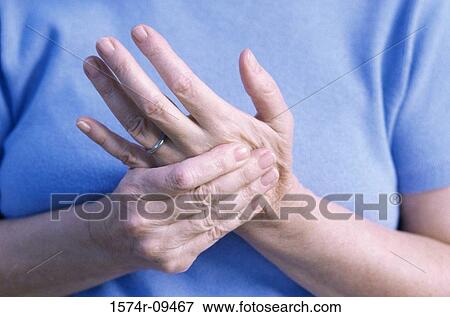 Stock Photo - Woman massaging her hand. Fotosearch