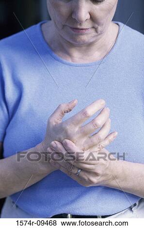 Stock Photo - Woman massaging her hand. Fotosearch