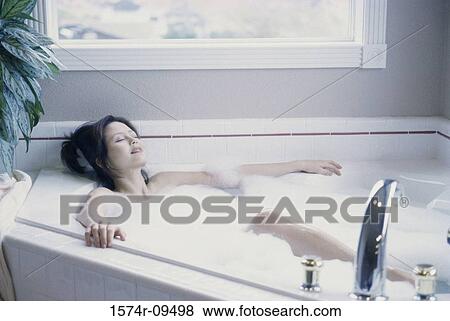 Stock Photo - Woman relaxing in a bathtub. Fotosearch