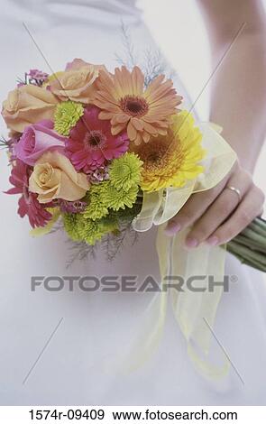 Woman's hand holding a bouquet of flowers View Large Photo Image Stock Photo - Woman's hand holding a bouquet of flowers. Fotosearch