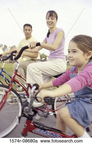 Young couple cycling with their daughter View Large Photo Image Stock Image - Young couple cycling with their daughter. Fotosearch