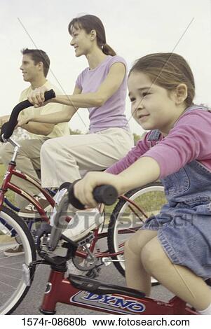 Young couple cycling with their daughter View Large Photo Image Stock Image - Young couple cycling with their daughter. Fotosearch