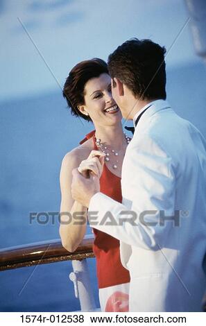 Stock Photo - Young couple dancing on the deck of a cruise ship. Fotosearch