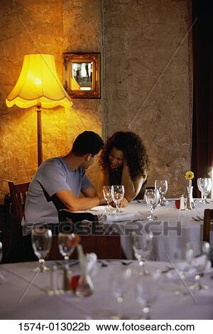 Young couple dining in a restaurant View Large Photo Image Stock Image - Young couple dining in a restaurant. Fotosearch