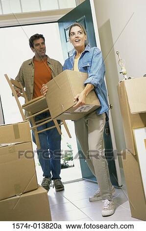 Young couple entering into their new house View Large Photo Image Stock Image - Young couple entering into their new house. Fotosearch