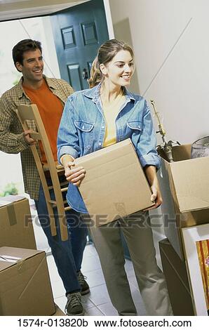 Stock Image - Young couple entering their new house. Fotosearch