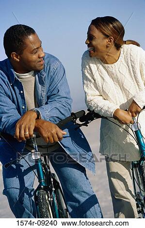 Young couple on bicycles at the beach View Large Photo Image Stock Image - Young couple on bicycles at the beach. Fotosearch