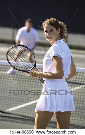 Young couple playing tennis View Large Photo Image Stock Image - Young couple playing tennis. Fotosearch