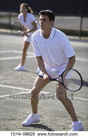 Young couple playing tennis View Large Photo Image Stock Photo - Young couple playing tennis. Fotosearch