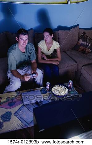 Stock Image - Young couple playing video games. Fotosearch