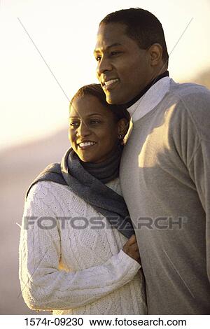 Young couple standing on the beach View Large Photo Image Stock Image - Young couple standing on the beach. Fotosearch