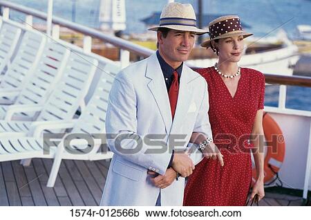 Young couple standing on the deck of a cruise ship View Large Photo Image Stock Image - Young couple standing on the deck of a cruise ship. Fotosearch