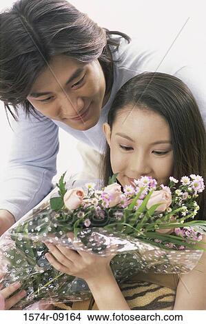 Young couple with a bouquet of flowers View Large Photo Image Picture - Young couple with a bouquet of flowers. Fotosearch