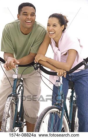 Young couple with bicycles at the beach View Large Photo Image Stock Image - Young couple with bicycles at the beach. Fotosearch