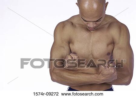 Young man flexing his biceps View Large Photo Image Stock Image - Young man flexing his biceps. Fotosearch