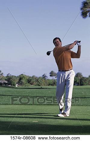 Stock Photo - Young man playing golf. Fotosearch