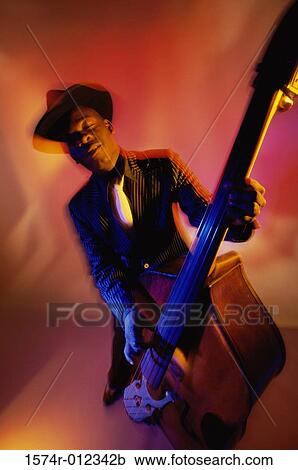 Young man playing the double bass View Large Photo Image Stock Image - Young man playing the double bass. Fotosearch