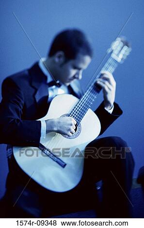 Stock Photo - Young man playing the guitar. Fotosearch
