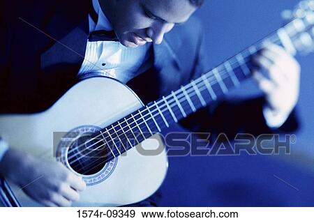 Young man playing the guitar View Large Photo Image Stock Photo - Young man playing the guitar. Fotosearch