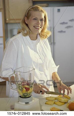 Young pregnant woman cutting fruit View Large Photo Image Stock Photography - Young pregnant woman cutting fruit. Fotosearch