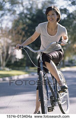 Young woman cycling View Large Photo Image Stock Image - Young woman cycling. Fotosearch