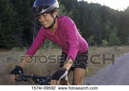 Young woman cycling View Large Photo Image Stock Image - Young woman cycling. Fotosearch