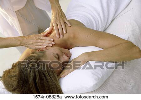 Stock Image - Young woman getting a back massage. Fotosearch