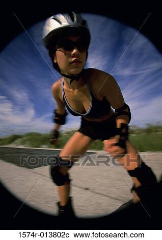 Young woman inline skating on a road View Large Photo Image Stock Image - Young woman inline skating on a road. Fotosearch