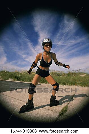 Young woman inline skating on a road View Large Photo Image Stock Image - Young woman inline skating on a road. Fotosearch