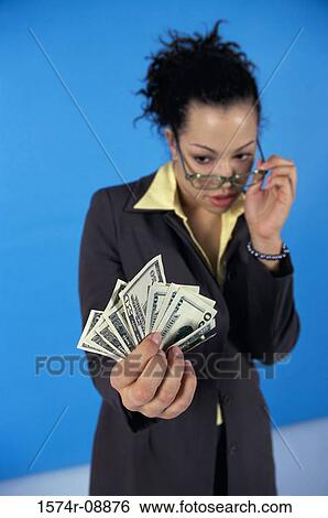 Young woman looking at paper money View Large Photo Image Stock Photograph - Young woman looking at paper money. Fotosearch