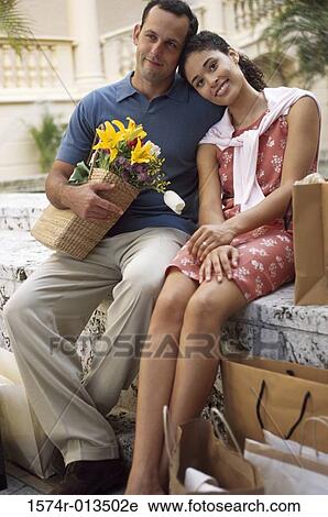 Stock Image - Young woman resting her head on a young man's shoulder. Fotosearch