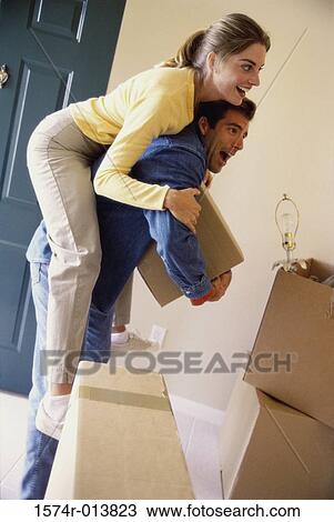 Young woman riding piggyback on a young man View Large Photo Image Stock Image - Young woman riding piggyback on a young man. Fotosearch