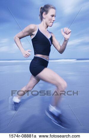 Young woman running on the beach View Large Photo Image Stock Image - Young woman running on the beach. Fotosearch