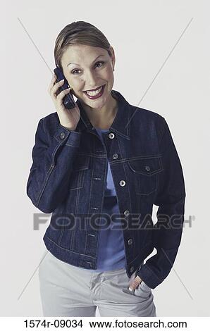 Young woman talking on a mobile phone View Large Photo Image Picture - Young woman talking on a mobile phone. Fotosearch