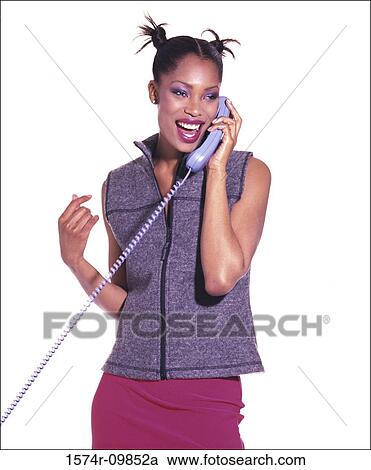 Stock Image - Young woman talking on a telephone. Fotosearch
