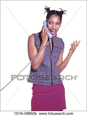 Stock Image - Young woman talking on a telephone. Fotosearch
